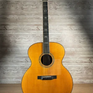 Stunning Made in Canada Jumbo acoustic. 1995. Solid cedar top with ornate koa back and sides. Very nice rosette and beautiful inlays on the fingerboard, and check out that headstock! Large, rich and loud tone with Fishman electronics. Some light general wear throughout as pictured, but nothing significant. Playing great with a fresh setup. Includes original hardshell case.